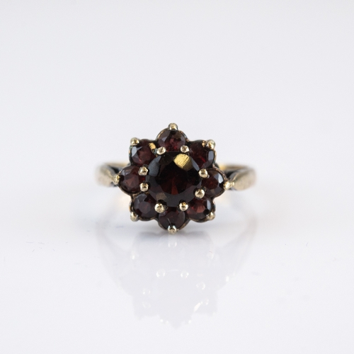 60 - SILVER GILT AND GARNET DAISY CLUSTER RING, ring size N/O