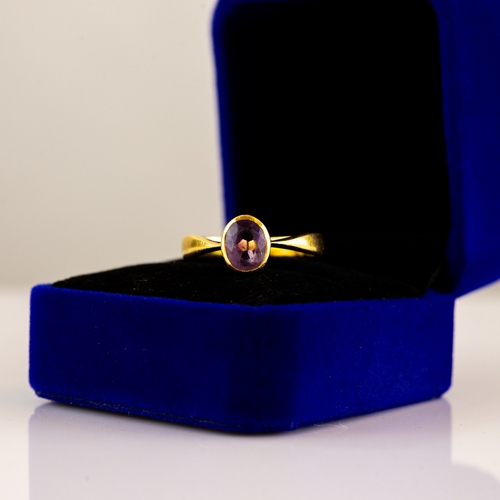 172 - GOLD COLOURED METAL RING collet set with an oval amethyst, 4.3gms, ring size 'M/N' (tests 21.55ct)