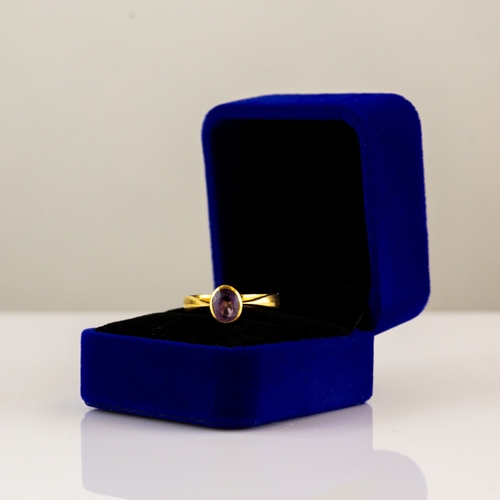 172 - GOLD COLOURED METAL RING collet set with an oval amethyst, 4.3gms, ring size 'M/N' (tests 21.55ct)