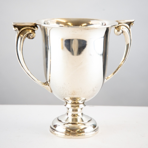 342 - GEORGE V TWO HANDLED SILVER TROPHY CUP, of typical form with embossed scroll handles, 7” (17.8... 