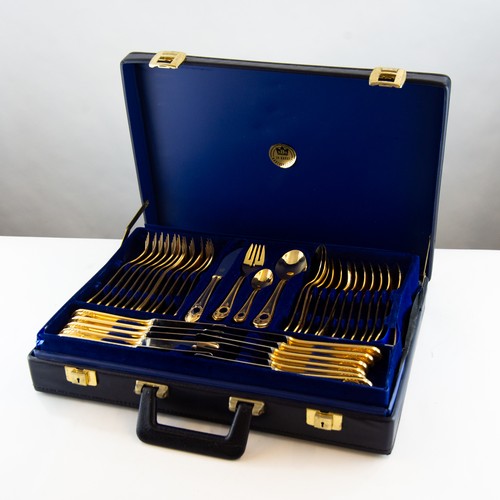 369 - CASED PART TABLE SERVICE OF GOLD PLATED CUTLERY, with blue enamelled cabochons to the base of the ha... 