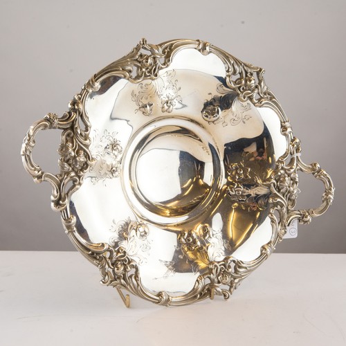 305 - VICTORIAN ENGRAVED AND EMBOSSED SILVER TWO HANDLED FRUIT DISH, of shallow, circular form with floral... 