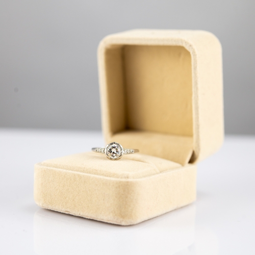 149 - PLATINUM RING, WITH A ROUND BRILLIANT CUT SOLITAIRE DIAMOND in a rubbed setting, approximately .60ct... 