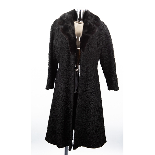 310 - BLACK PERSIAN LAMB COAT with black mink revered collar, slit pockets, fastening with a black suede b... 