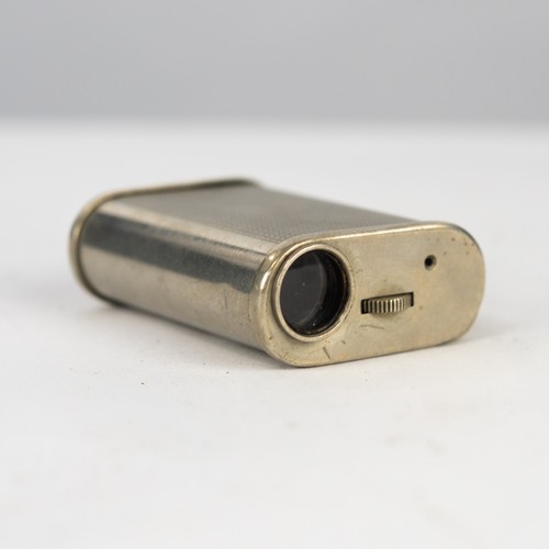 70 - MID-20TH CENTURY SPY CAMERA in rounded oblong plated metal case with engine turned decoration to sid... 