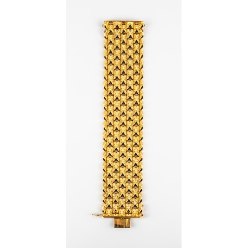 51 - 18ct GOLD BROAD CUFF BRACELET with each panel link having two opposed polished chevrons on a foliate... 