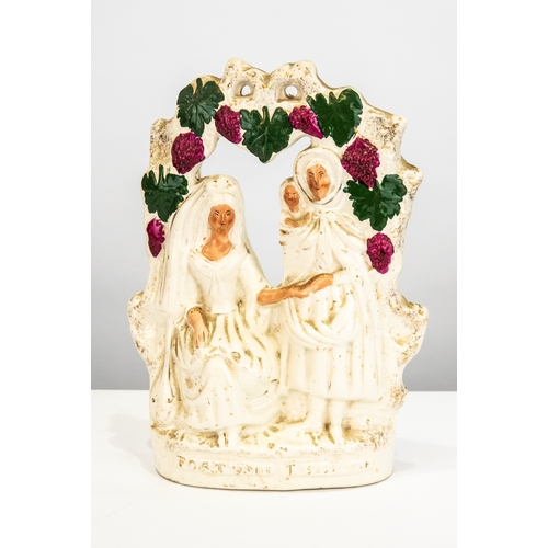 82 - 19TH CENTURY STAFFORDSHIRE POTTERY FLAT BACK GROUP 'FORTUNE TELLER', with arched floral bocage, the ... 
