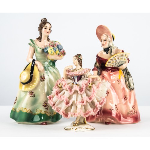95 - TWO KERAMOS, AUSTRIAN POTTERY FEMALE FIGURES, each modelled in a floral dress, one holding flowers, ... 
