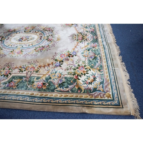 6 - LARGE WASHED CHINESE CARPET of Aubusson design, having large floral centre oval medallion, spandrels... 