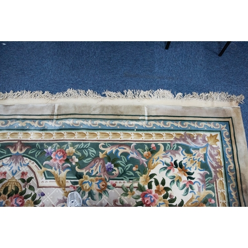 6 - LARGE WASHED CHINESE CARPET of Aubusson design, having large floral centre oval medallion, spandrels... 