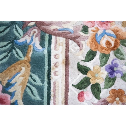 6 - LARGE WASHED CHINESE CARPET of Aubusson design, having large floral centre oval medallion, spandrels... 