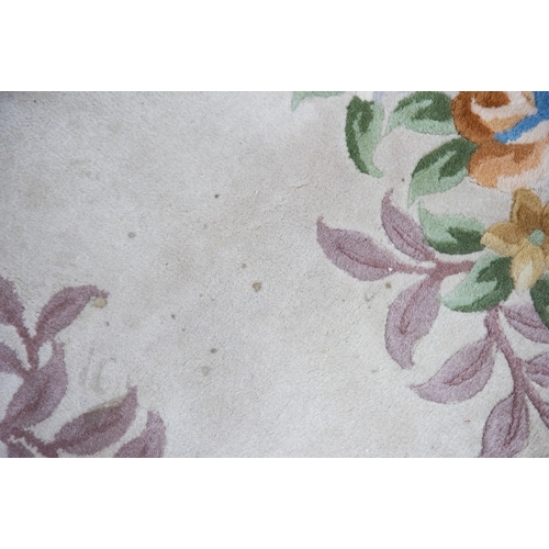 6 - LARGE WASHED CHINESE CARPET of Aubusson design, having large floral centre oval medallion, spandrels... 