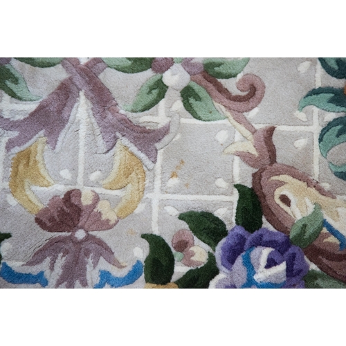 6 - LARGE WASHED CHINESE CARPET of Aubusson design, having large floral centre oval medallion, spandrels... 