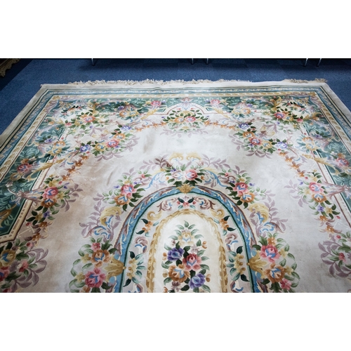 6 - LARGE WASHED CHINESE CARPET of Aubusson design, having large floral centre oval medallion, spandrels... 