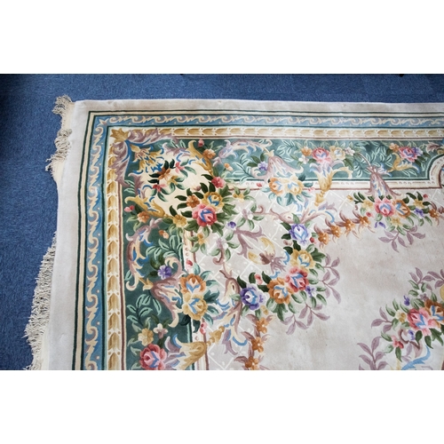 6 - LARGE WASHED CHINESE CARPET of Aubusson design, having large floral centre oval medallion, spandrels... 
