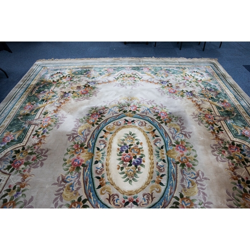 6 - LARGE WASHED CHINESE CARPET of Aubusson design, having large floral centre oval medallion, spandrels... 