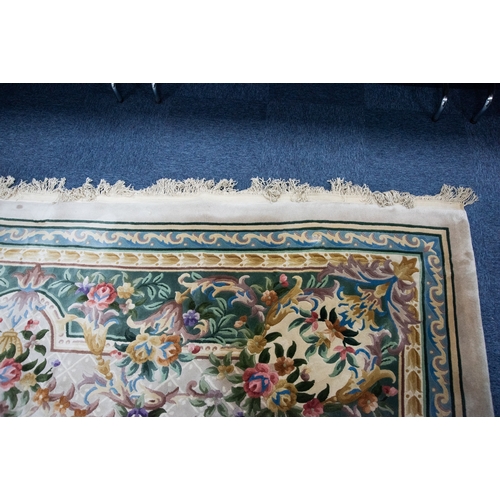 6 - LARGE WASHED CHINESE CARPET of Aubusson design, having large floral centre oval medallion, spandrels... 