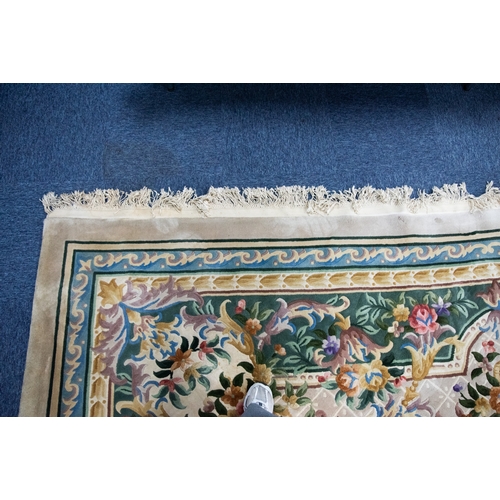 6 - LARGE WASHED CHINESE CARPET of Aubusson design, having large floral centre oval medallion, spandrels... 