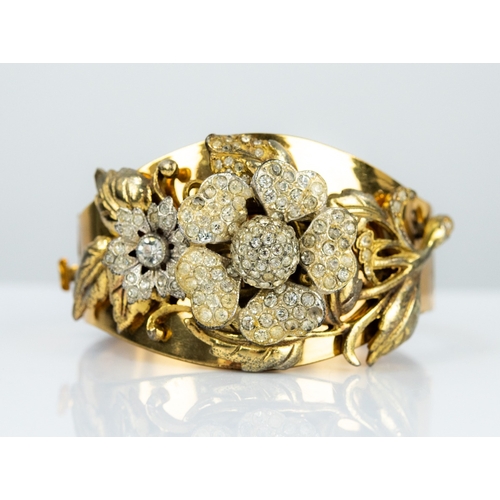 125 - VINTAGE GOLD PLATED BROAD HINGE OPENING BANGLE, the broadening top overlaid in free relief with a la... 