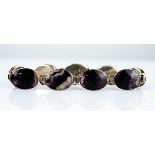 124 - SILVER AND BLUE JOHN BRACELET with nine cabochon oval collet set blue john links, 7½