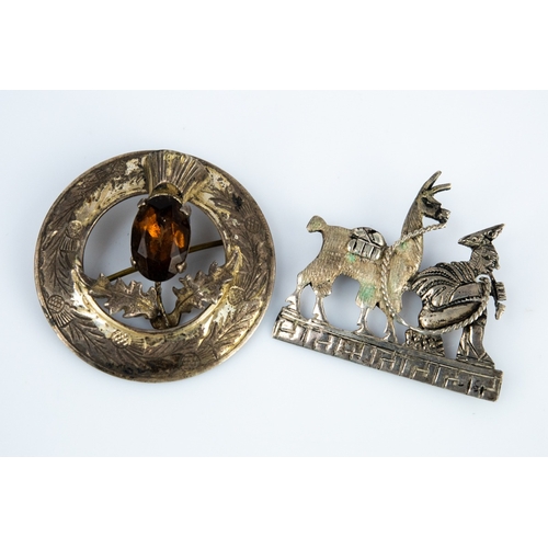 93 - STERLING SILVER SCOTTISH CIRCULAR BROOCH, the open centre having a thistle set with an oval brown st... 