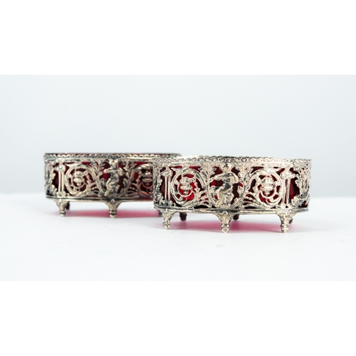 177 - ATTRACTIVE PAIR OF NINETEENTH CENTURY PIERCED STERLING SILVER OPEN SALTS WITH RUBY GLASS LINERS, eac... 