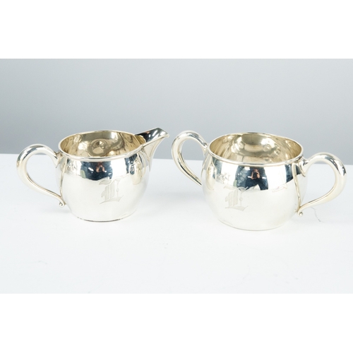 173 - PLAIN STERLING SILVER SUGAR AND CREAM SET, of orbicular form with scroll handles, initialled, 2 ½” (... 
