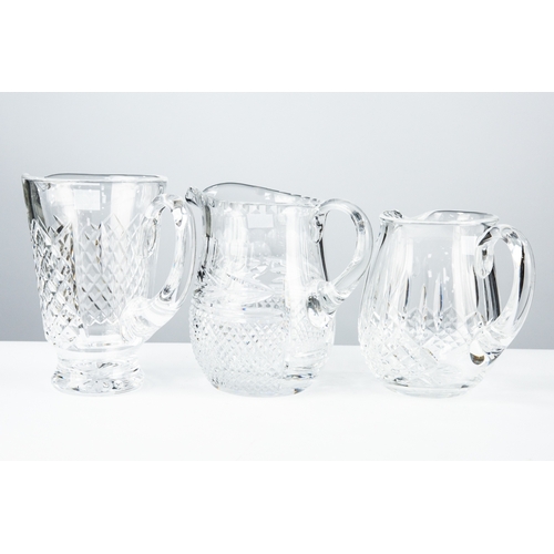 87 - TWO WATERFORD CUT GLASS WATER JUGS, one of tapering from, 7 ½” (19cm) high, the other of ovoid form ... 