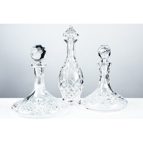 82 - THREE IRISH CUT GLASS DECANTERS AND STOPPERS, comprising: WATERFORD SHANNON JUBILEE PATTERN SKITTLE ... 