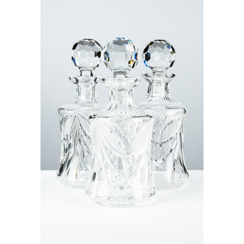 81 - SET OF THREE WATERFORD CUT GLASS DECANTERS AND STOPPERS, each of mallet form with orbicular stopper,... 