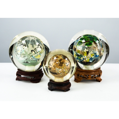 64 - THREE POST-WAR CHINESE INTERNALLY PAINTED THICKLY WALLED HOLLOW GLASS SPHERES on stands (3)