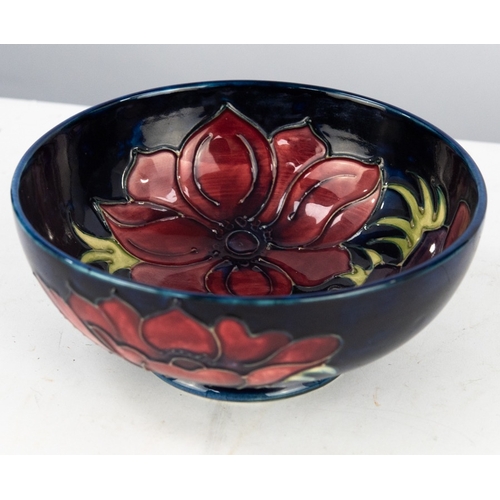 129 - SECOND QUALITY WALTER MOORCROFT ANEMONE PATTERN TUBE LINED POTTERY BOWL, of steep sided, footed form... 