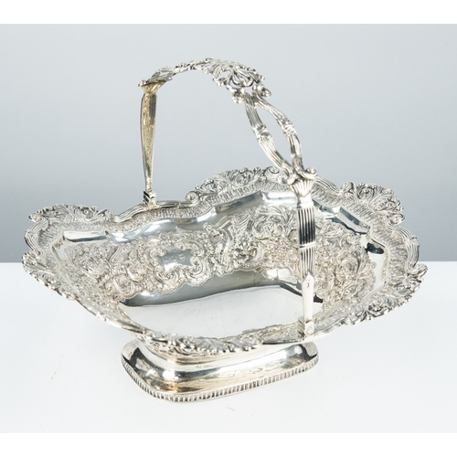 173 - ANGLO-INDIAN LATE 19TH CENTURY SILVER COLOURED METAL LARGE SWING HANDLED FRUIT BASKET, rococo repous... 