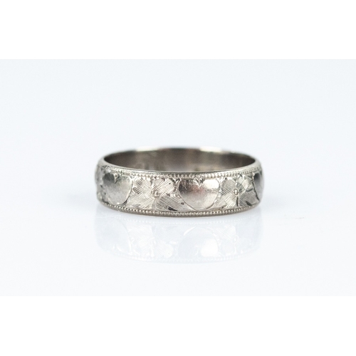 127 - 18ct WHITE GOLD BROAD WEDDING RING with chased decoration, 3.9gms