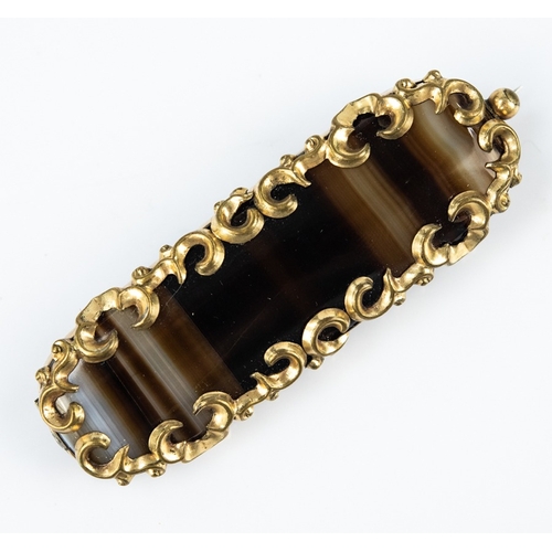 147 - VICTORIAN NARROW OBLONG BANDED AGATE BROOCH in pinchback rococo 'C' scroll frame, 2¾