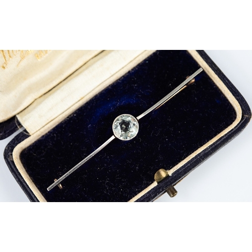 145 - GOLD COLOURED METAL (UNMARKED) BAR BROOCH collet set with a centre white stone, 3.6gms, in Lloyd, Pa... 