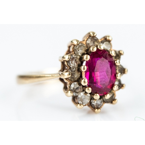 139 - 9ct GOLD OVAL CLUSTER RING set with centre oval ruby and surround of tiny white stones, 2.8gms, ring... 
