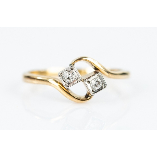 130 - 18ct GOLD CROSSOVER RING with two small round brilliant cut diamonds in square settings, 2.2gms, rin... 