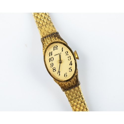 26 - LADY'S CARAVELLE GOLD PLATED BRACELET WATCH with mechanical movement, white oval Arabic dial, integr... 