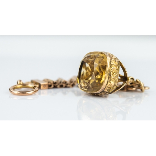 121 - ANTIQUE GOLD COLOURED METAL FOB SEAL, set with a CITRINE and the GOLD COLOURED METAL SHORT GATE LINK... 
