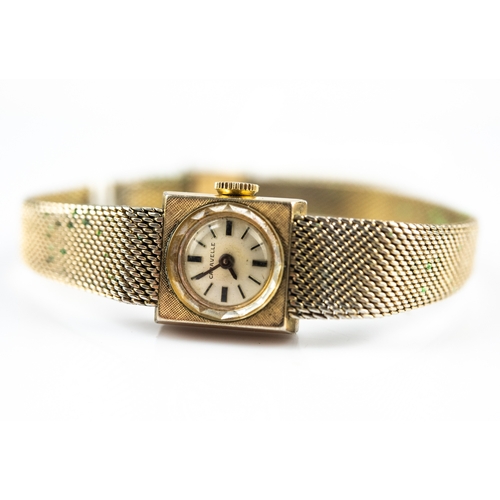 18 - LADY'S CARAVELLE GOLD PLATED BRACELET WATCH with mechanical movement, small case, circular silvered ... 