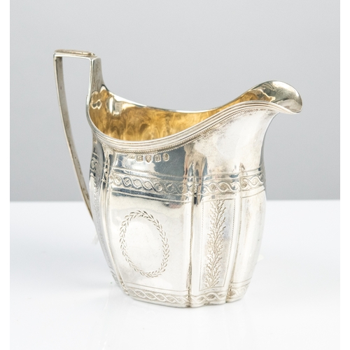 176 - GEORGE III SILVER CREAM JUG of fluted helmet shape with reeded top edge and angular handle, bright c... 