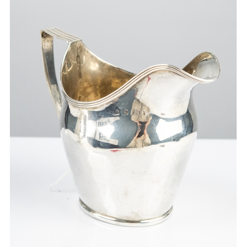 175 - GEORGE III SILVER PLAIN HELMET-SHAPED CREAM JUG with reeded edge and reeded angular handle, low plin... 