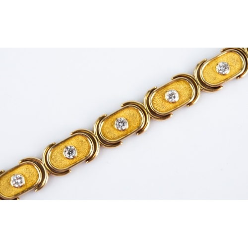 123 - GOLD AND DIAMOND BRACELET with ten panel links of rounded oblong form, each collet set with a round ... 