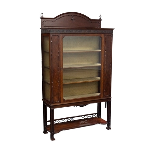 80 - EARLY TWENTIETH CENTURY CARVED MAHOGANY DISPLAY CABINET, the oblong, moulded top surmounted by a sho... 