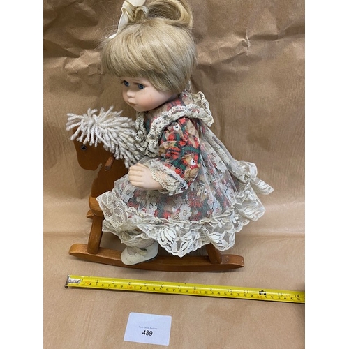 489 - Leonardo Collection china doll on a rocking horse - Section O5