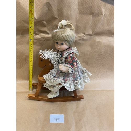 489 - Leonardo Collection china doll on a rocking horse - Section O5