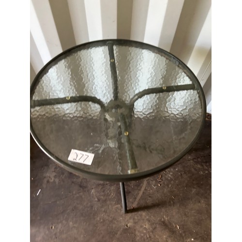 277 - Glass topped garden table - 72 x 60cm dia approx.