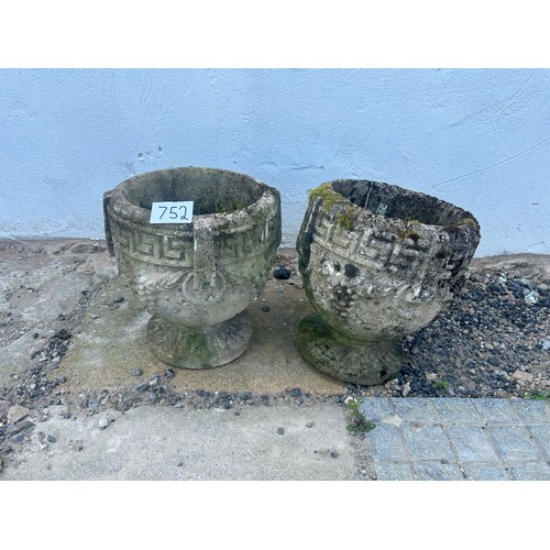 752 - A pair of weathered stone garden urns