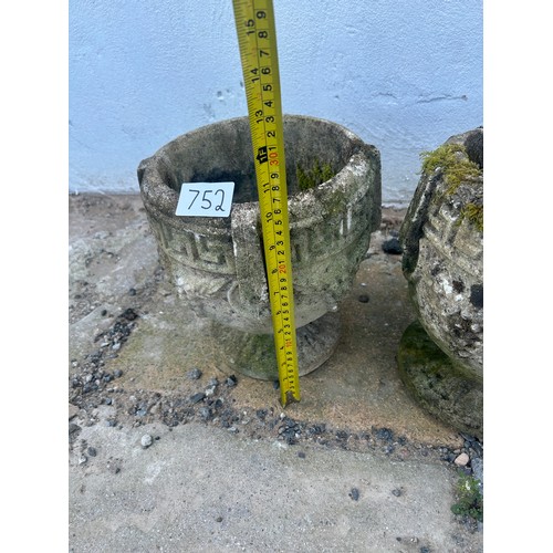 752 - A pair of weathered stone garden urns